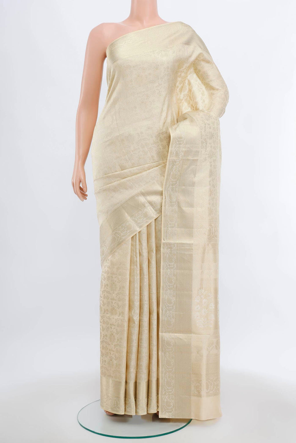 Cream Soft Silk Saree with Zari Butta on the body and Silk Border.  displayed on a mannequin