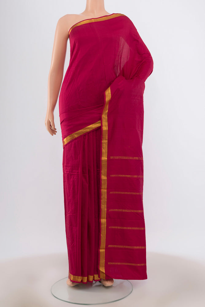 Maroon Kanchipuram Silk Saree with Plain Body and Zari Border.  displayed on a mannequin