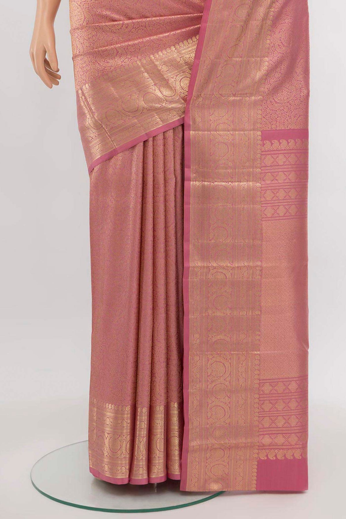 Pleats and pallu of Golden Peach Kanchipuram Silk Saree with Zari Butta on the body and Silk Border. 