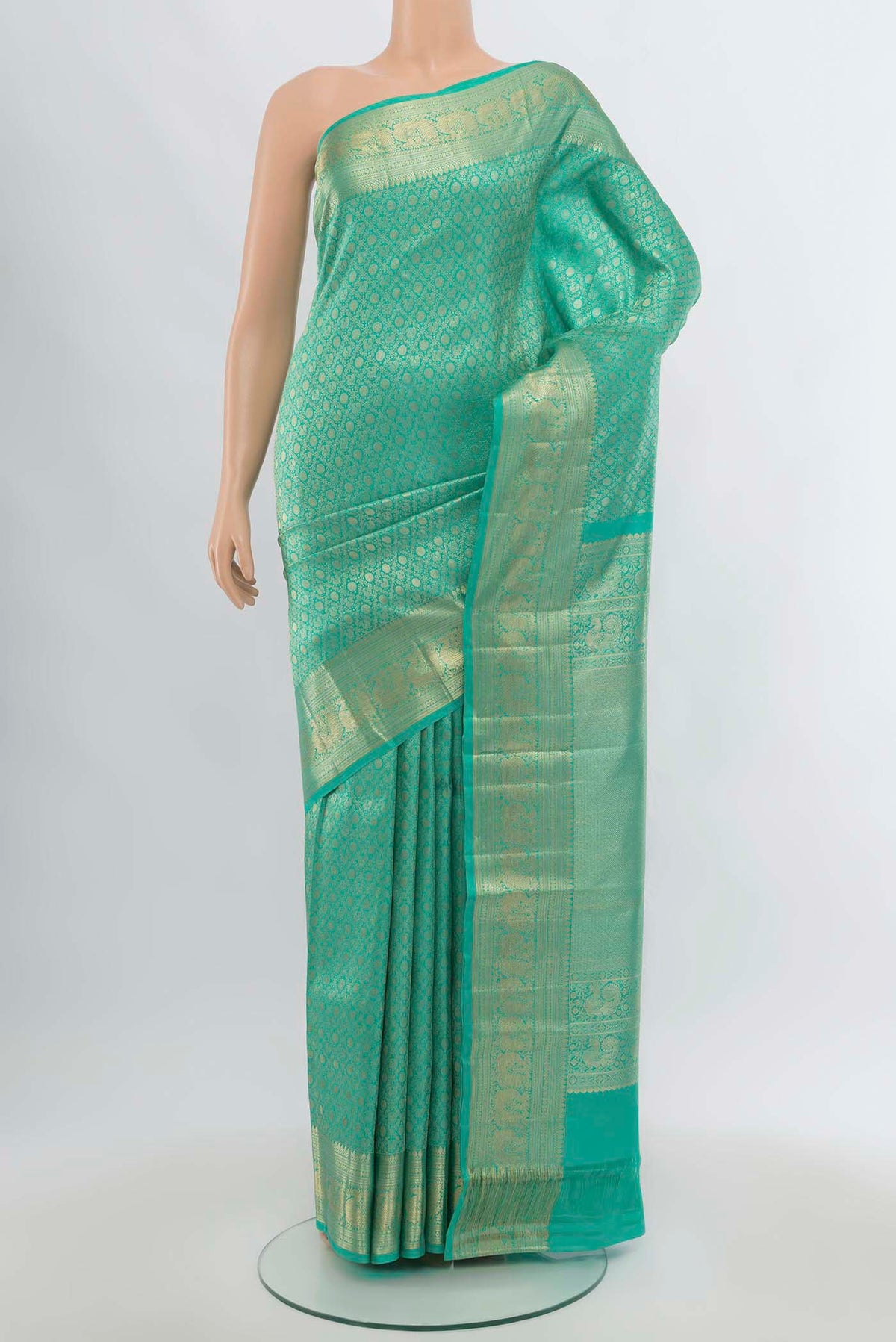 Sea Green Kanchipuram Silk Saree with Zari Butta on the body and Silk Border.  displayed on a mannequin