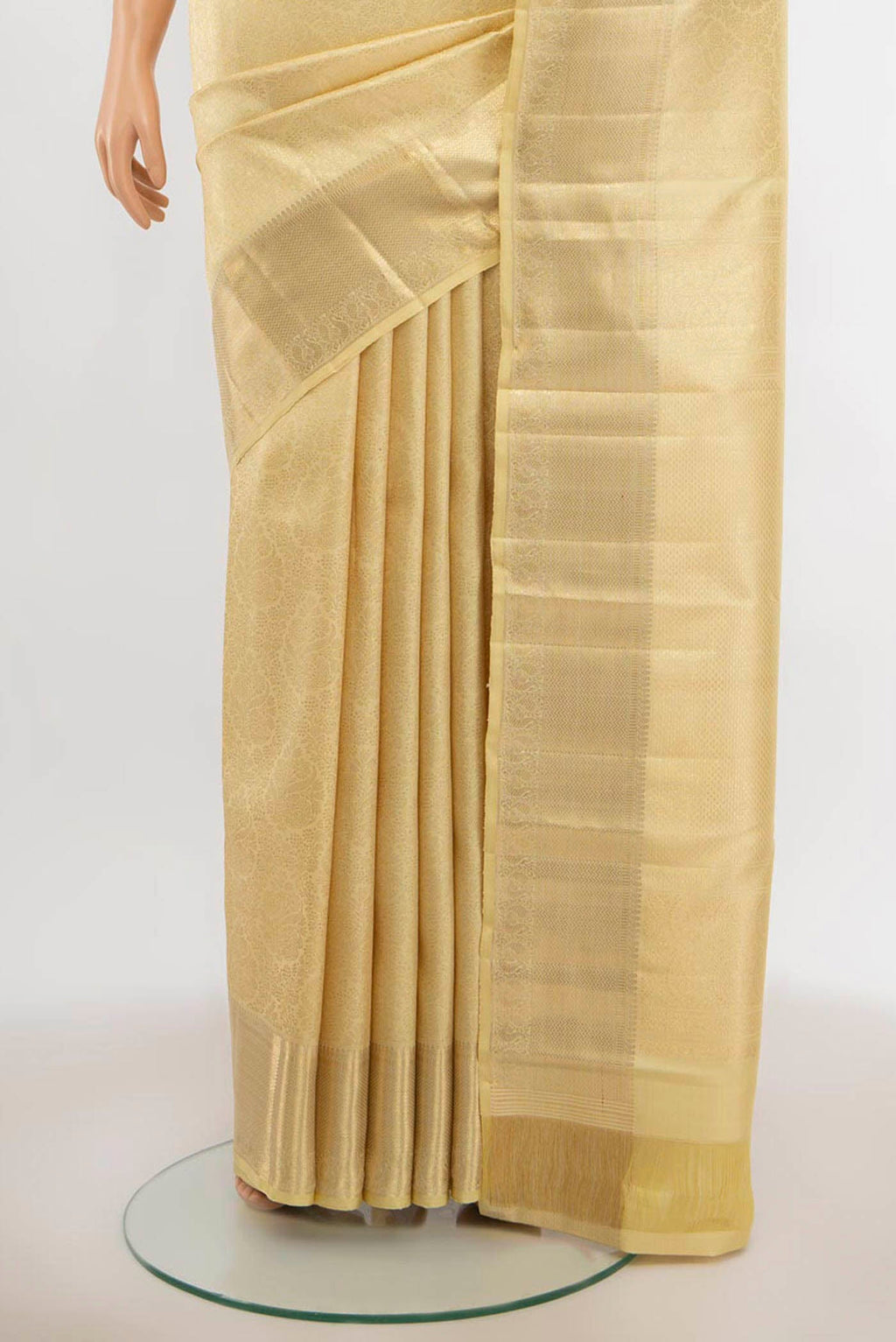 Pleats and pallu of Cream Kanchipuram Silk Saree with Zari Butta on the body and Silk Border. 