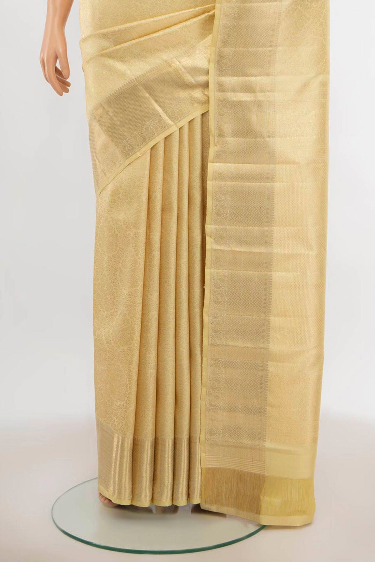 Pleats and pallu of Cream Kanchipuram Silk Saree with Zari Butta on the body and Silk Border. 