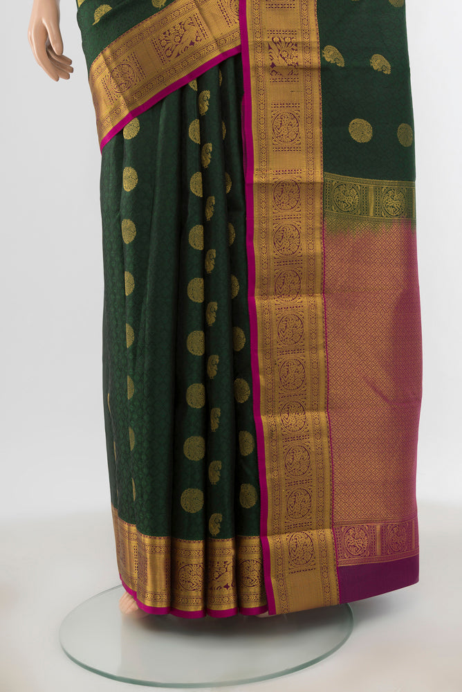 Pleats and pallu of Bottle Green Kanchipuram Silk Saree with Jacquard With Zari Butta on the body and Zari Border. 
