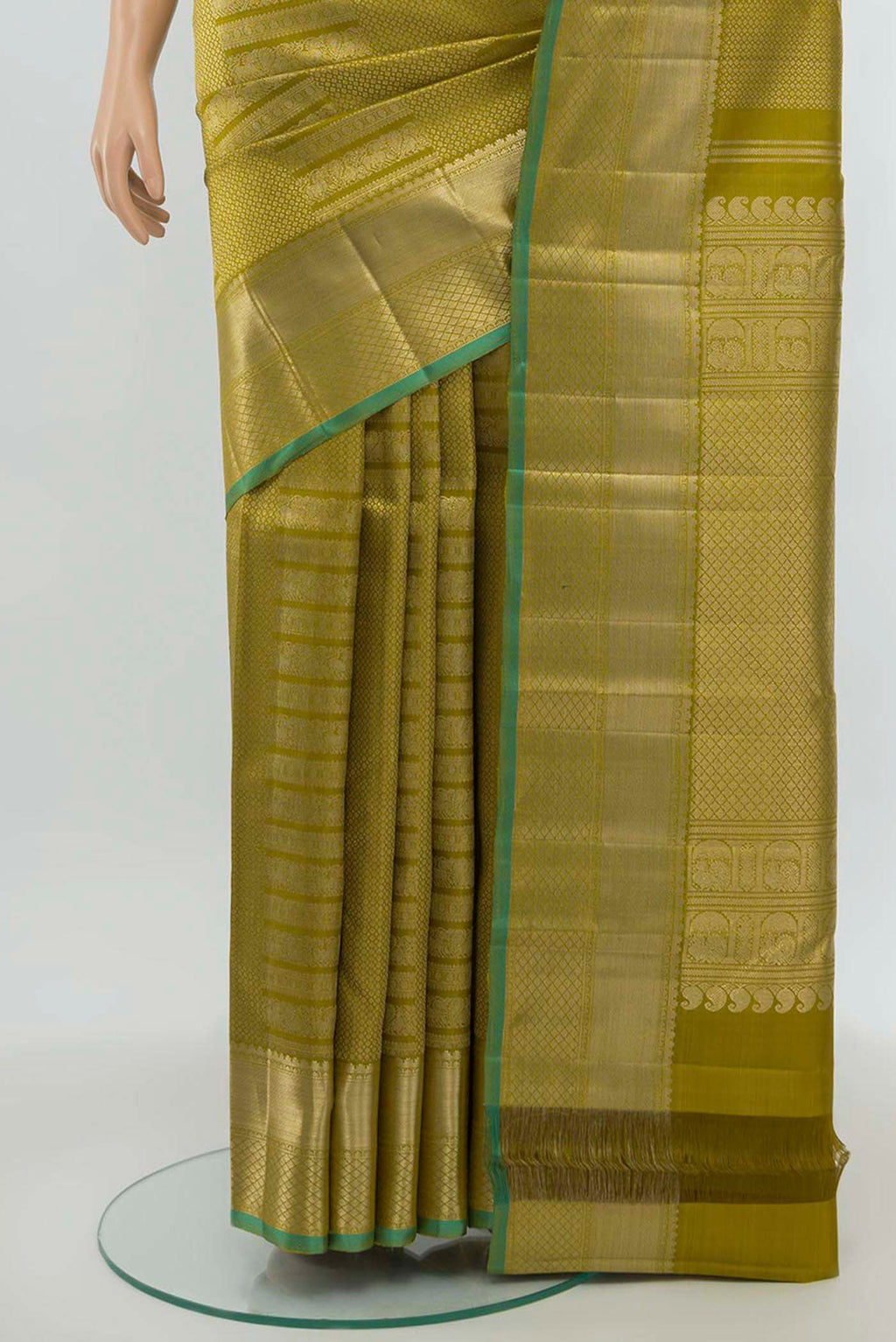 Pleats and pallu of Mehandi Green Kanchipuram Silk Saree with Zari Butta on the body and Silk Border. 