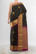 Black Kanchipuram Silk Saree with Zari Butta on the body and Zari Border.  displayed on a mannequin