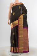 Black Kanchipuram Silk Saree with Zari Butta on the body and Silk Border.  displayed on a mannequin