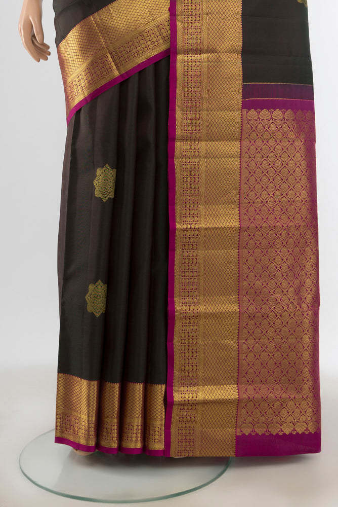 Pleats and pallu of Black Kanchipuram Silk Saree with Zari Butta on the body and Zari Border. 