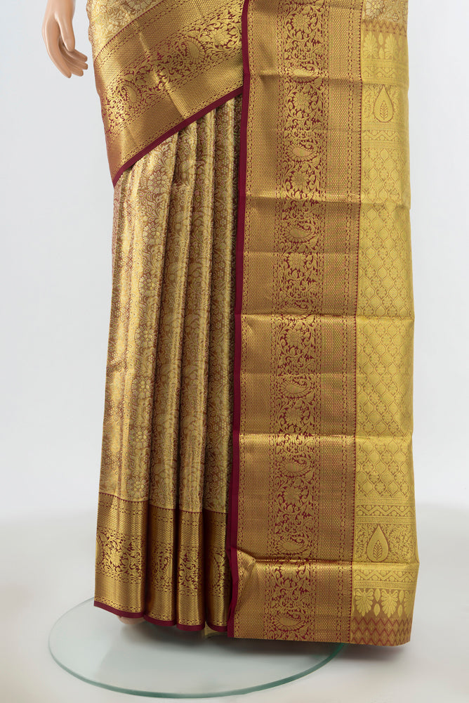 Pleats and pallu of Golden Kanchipuram Silk Saree with Zari Butta on the body and Zari Border. 