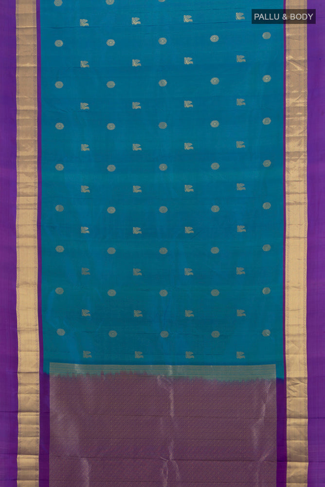 Flat view of Peacock Blue Kanchipuram Silk Saree with Zari Butta on the body and Zari Border. 