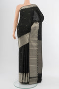 Black Kanchipuram Silk Saree with Zari Butta on the body and Silk Border.  displayed on a mannequin