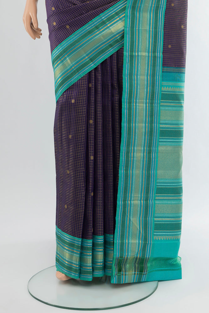 Pleats and pallu of Pure Silk Pure Zari Navy Blue Kanchipuram Saree with Zari Butta on the body and Silk Border. 