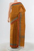 Brown Kanchipuram Silk Saree with Zari Butta on the body and Silk Border.  displayed on a mannequin