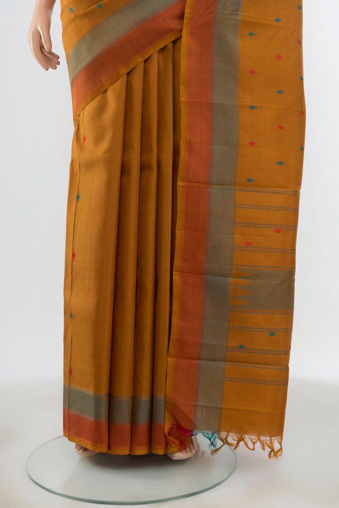 Pleats and pallu of Mustard Kanchipuram Silk Saree with Thread Butta on the body and Plain Border. 