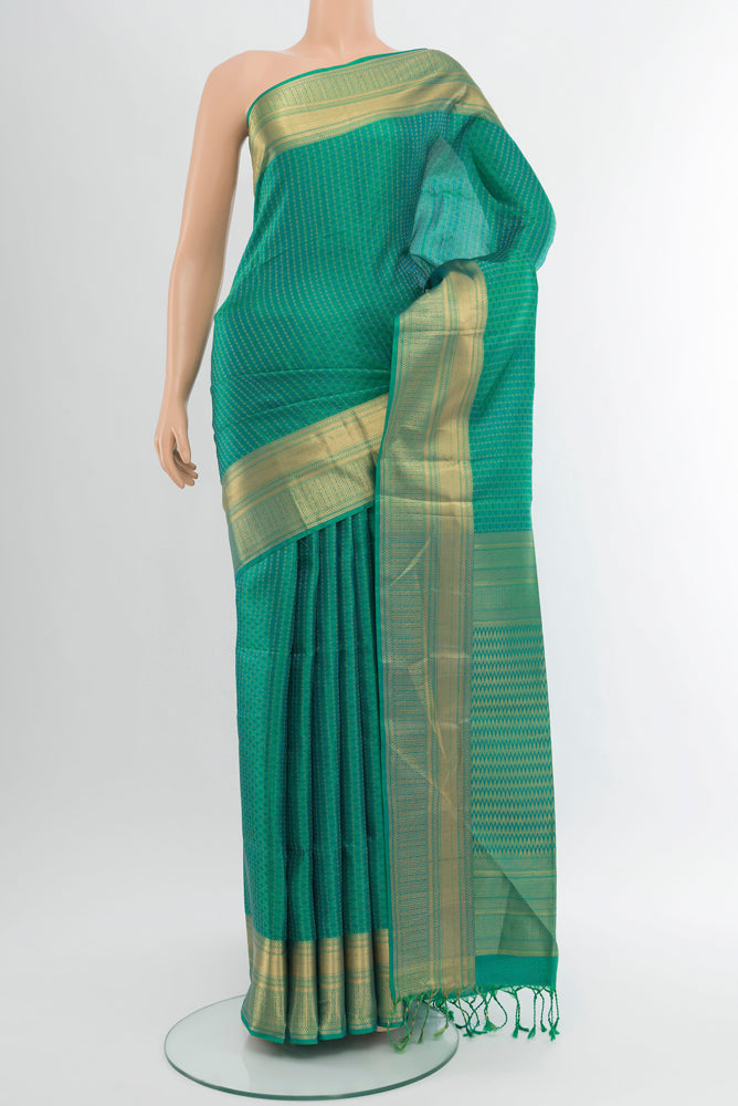 Pure Silk Pure Zari Light Green Soft Saree with Zari Butta on the body and Silk Border.  displayed on a mannequin