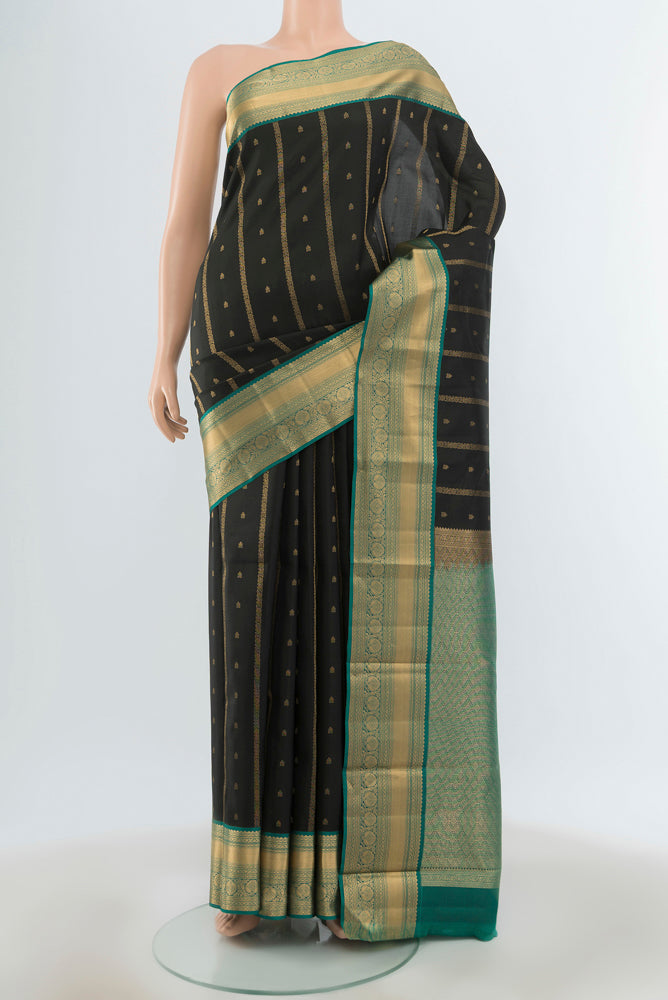 Black Kanchipuram Silk Saree with Zari Butta on the body and Zari Border.  displayed on a mannequin