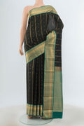Black Kanchipuram Silk Saree with Zari Butta on the body and Zari Border.  displayed on a mannequin