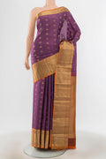Bronze Kanchipuram Silk Saree with Zari Butta on the body and Silk Border.  displayed on a mannequin