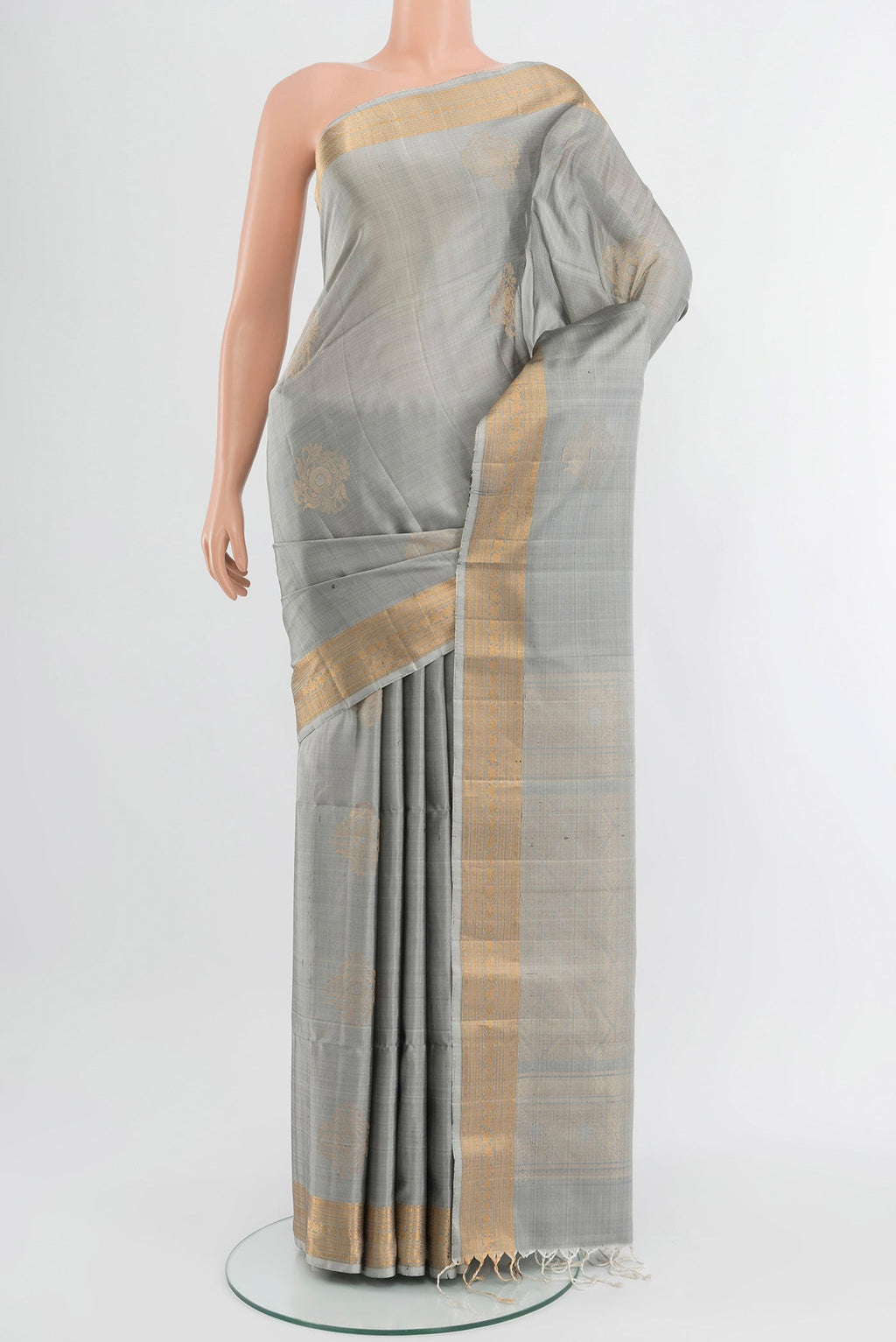 Davys Grey Soft Silk Saree with Zari Butta on the body and Zari Border.  displayed on a mannequin