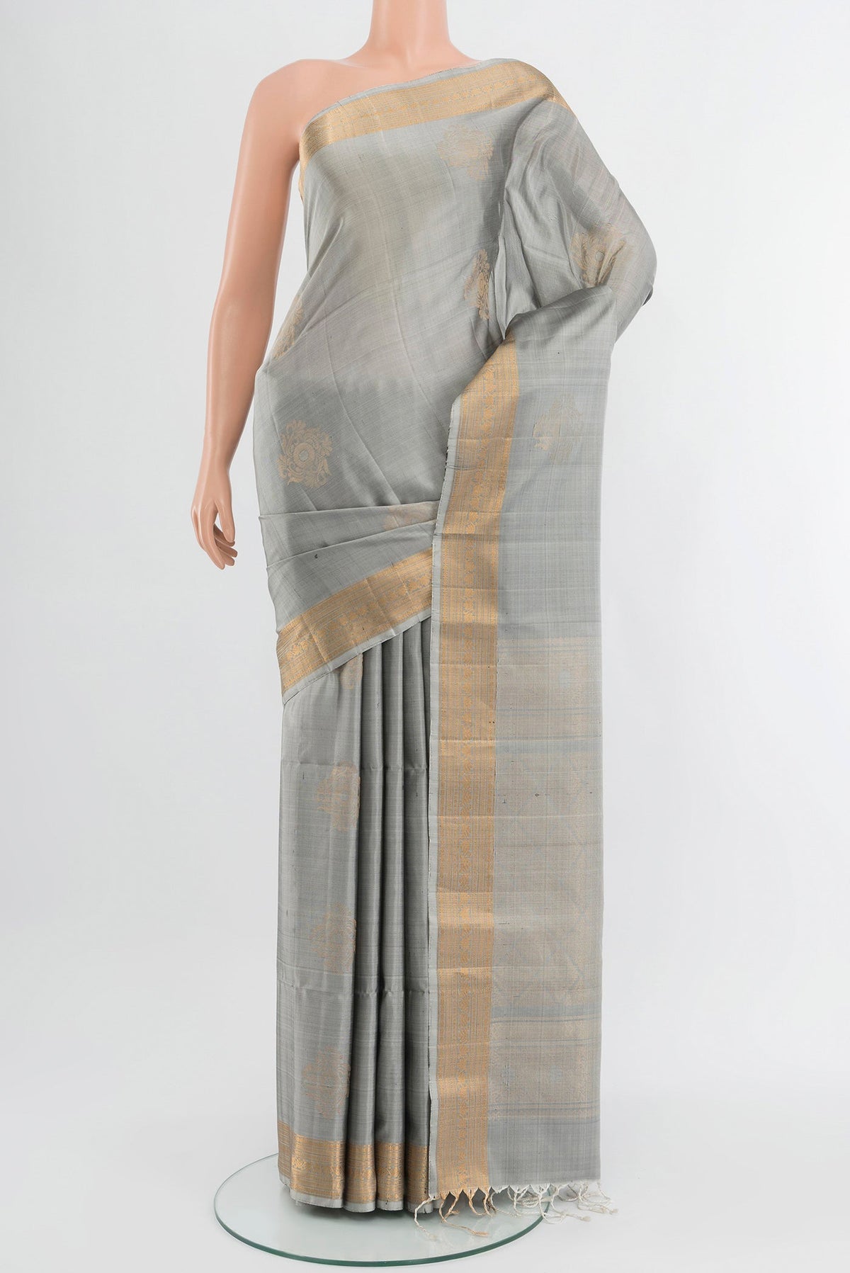 Davys Grey Soft Silk Saree with Zari Butta on the body and Zari Border.  displayed on a mannequin