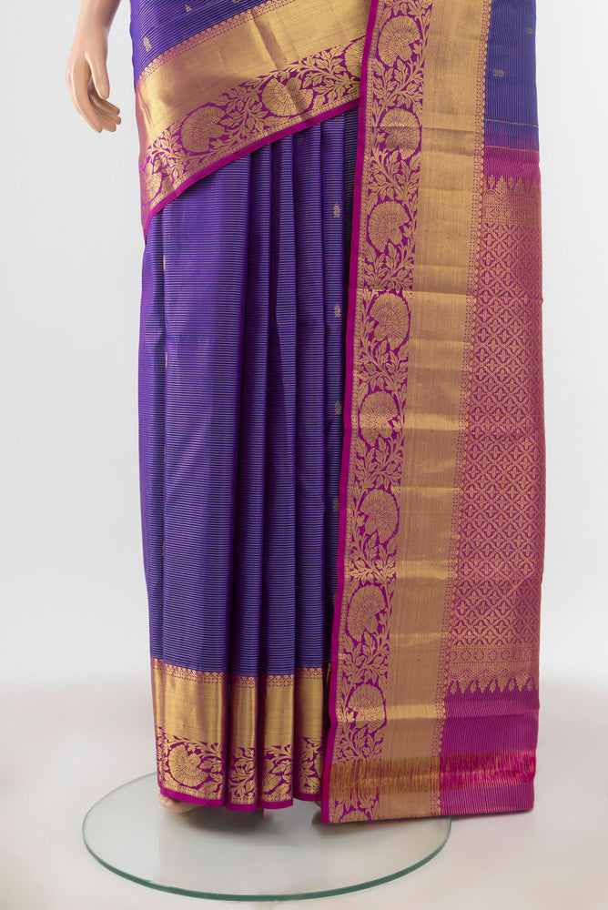 Pleats and pallu of Violet Kanchipuram Silk Saree with Zari Butta on the body and Silk Border. 