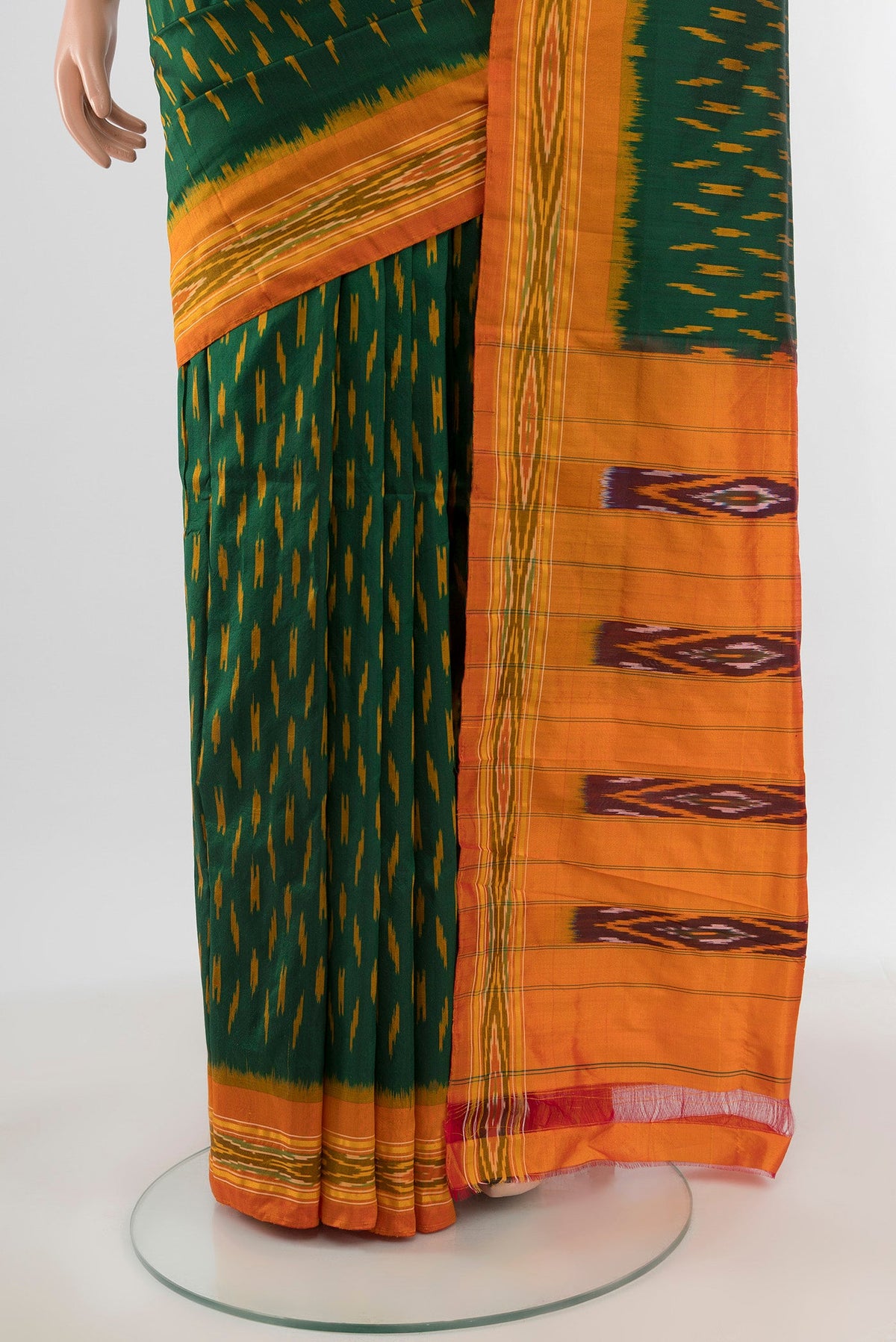 Pleats and pallu of Bottle Green Pochampally Silk Saree with Ikat design on the body and Ikat Border. 