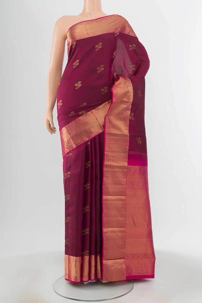 Maroon Kanjivaram Silk Saree with Zari Butta on the body and Zari Border.  displayed on a mannequin