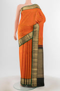 Orange Kanchipuram Silk Saree with Zari Butta on the body and Zari Border.  displayed on a mannequin