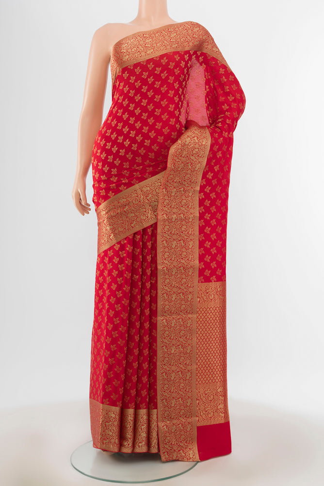 Red Georgette Saree with Zari Butta on the body and Silk Border.  displayed on a mannequin