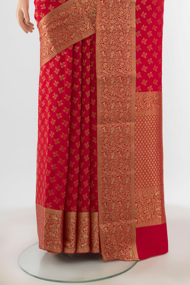 Pleats and pallu of Red Georgette Saree with Zari Butta on the body and Silk Border. 