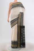 Off White Pochampally Silk Saree with Stripes on the body and Ikat Border.  displayed on a mannequin