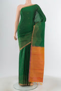 Green Soft Silk Saree with Zari Butta on the body and Zari Border.  displayed on a mannequin