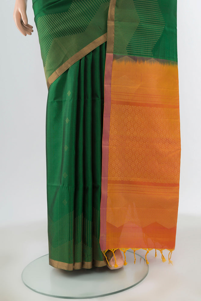 Pleats and pallu of Green Soft Silk Saree with Zari Butta on the body and Zari Border. 
