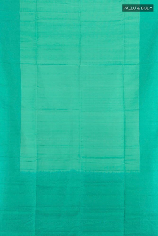 Flat view of Turquoise Soft Silk Saree with Zari Butta on the body and Plain Border. 