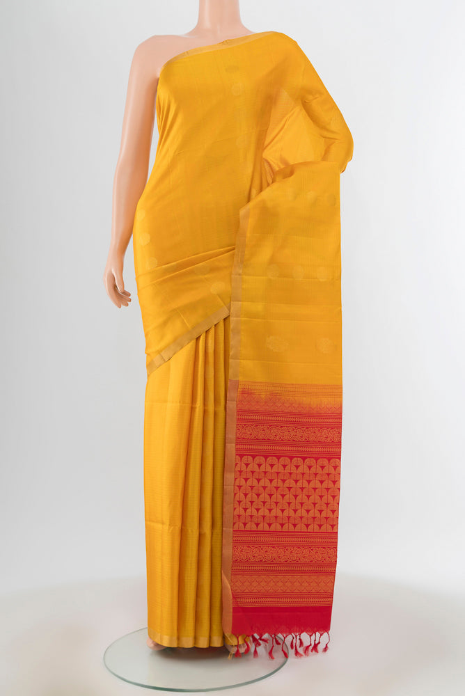 Yellow Soft Silk Saree with Zari Butta on the body and Zari Border.  displayed on a mannequin