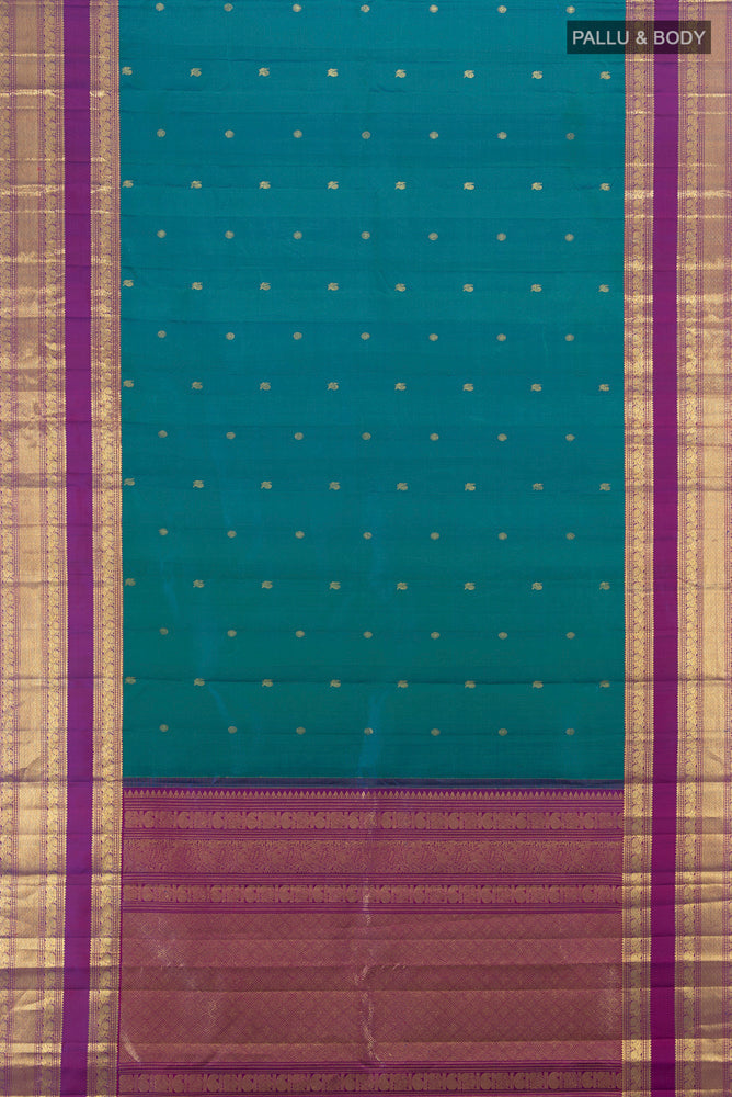 Flat view of Peacock Blue Kanchipuram Silk Saree with Zari Butta on the body and Zari Border. 