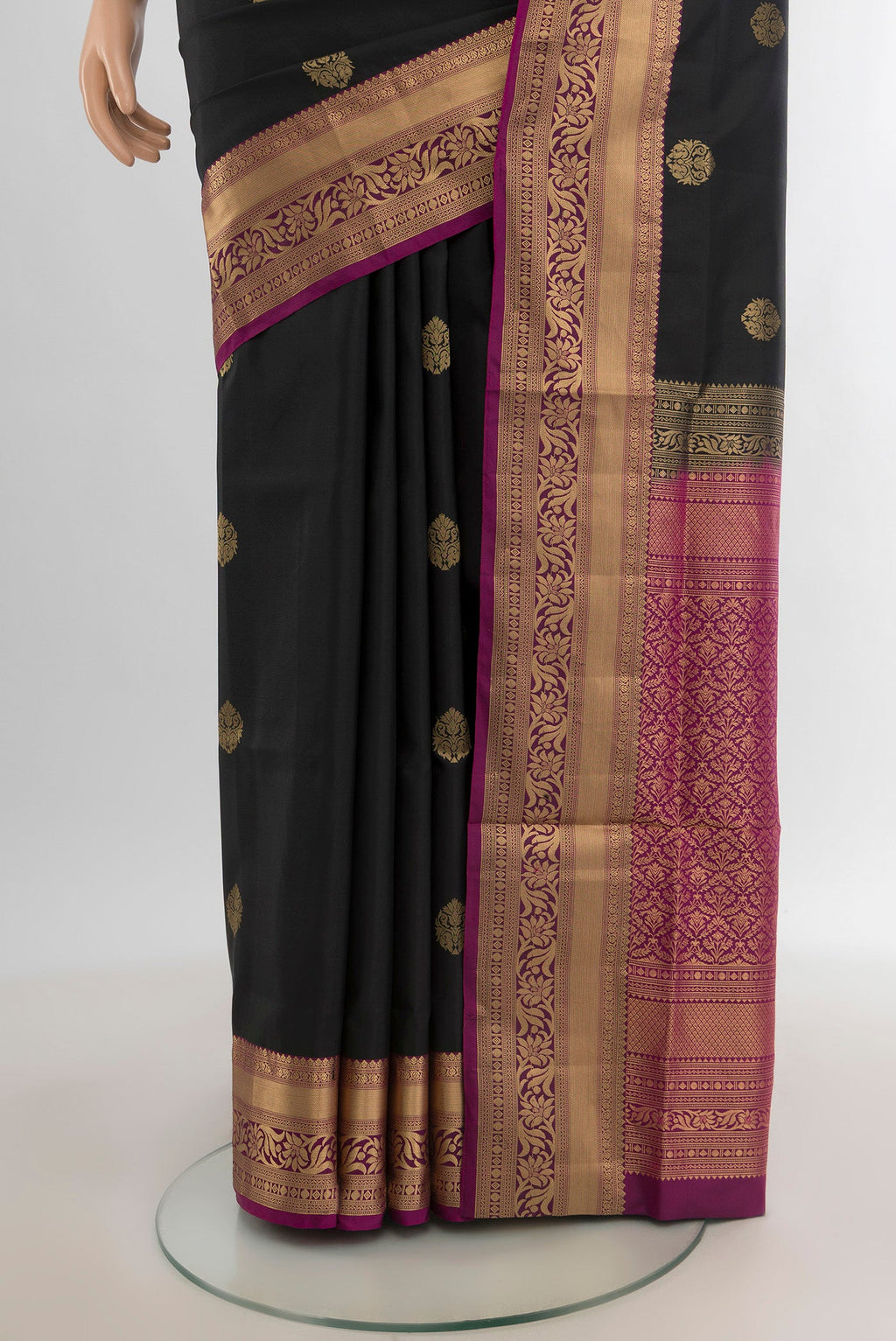 Pleats and pallu of Black Soft Silk Saree with Zari Butta on the body and Zari Border. 