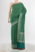 Green Banarasi Silk Saree with Zari And Thread Butta on the body and Zari Border.  displayed on a mannequin