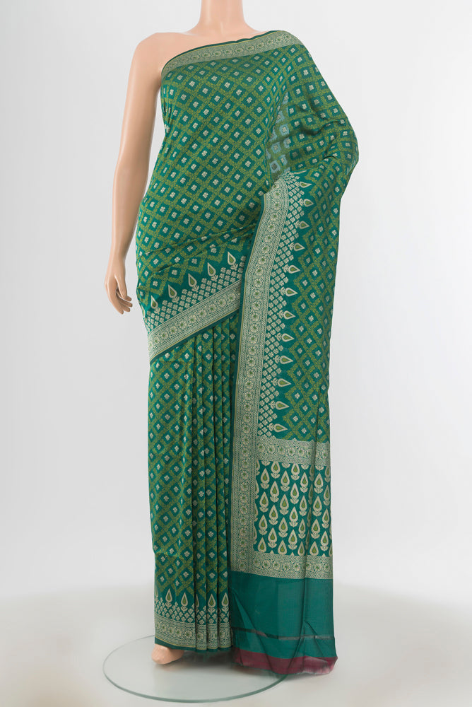 Green Banarasi Silk Saree with Zari And Thread Butta on the body and Zari Border.  displayed on a mannequin