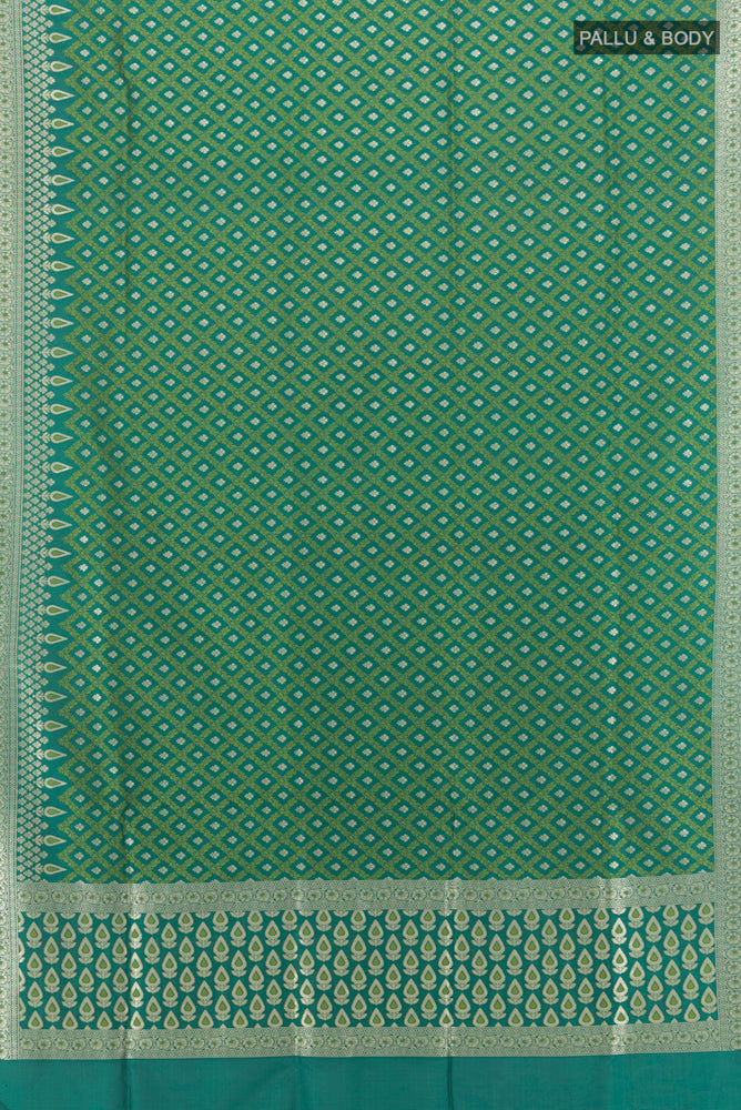Flat view of Green Banarasi Silk Saree with Zari And Thread Butta on the body and Zari Border. 
