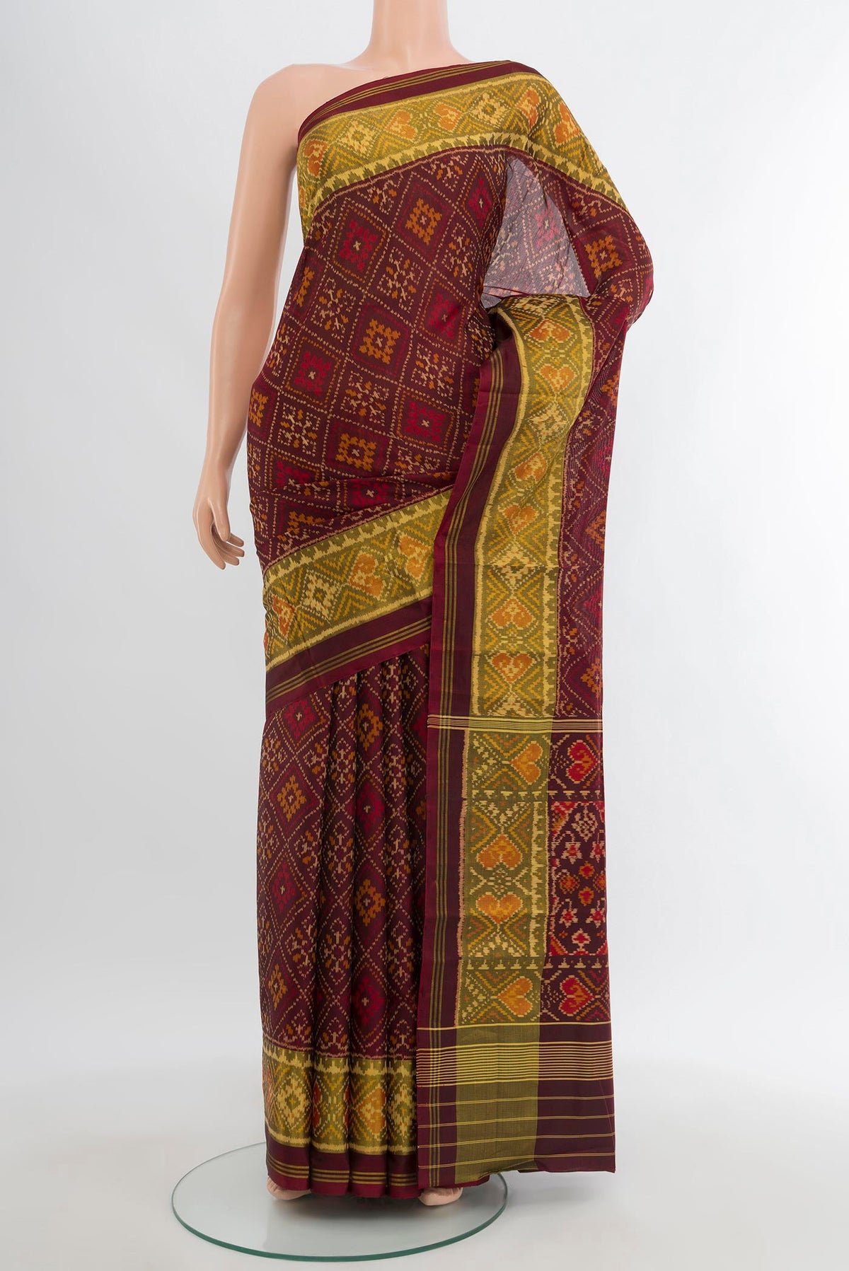 Coffee Brown Rajkot Patola Silk Saree with Pure Ikat on the body and Ikat Border.  displayed on a mannequin