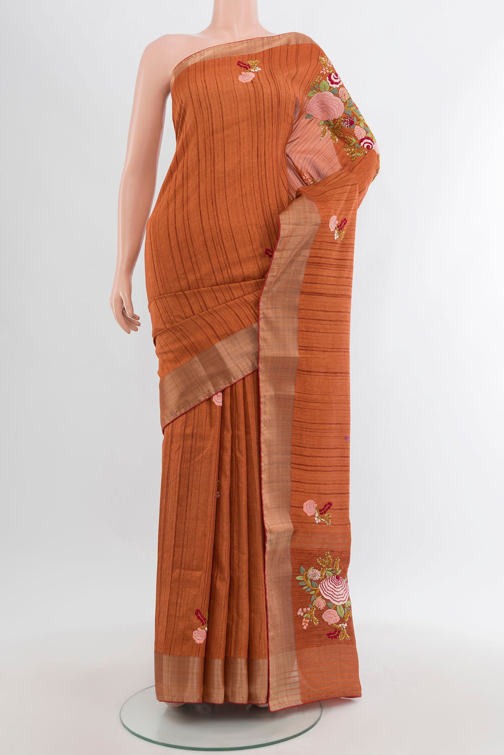 Rust Blended Art Silk Saree with Embroidery on the body and Zari Border.  displayed on a mannequin