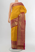 Yellow Kanchipuram Silk Saree with Zari Butta on the body and Silk Border.  displayed on a mannequin