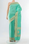 Sky Blue Banarasi Katan Silk Saree with Zari Butta on the body and Silk Border.  displayed on a mannequin