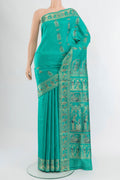 Turquoise Baluchari Silk Saree with Zari And Thread Butta on the body and Zari Border.  displayed on a mannequin