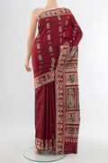 Maroon Baluchari Silk Saree with Zari Butta on the body and Silk Border.  displayed on a mannequin