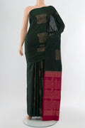 Bottle Green Soft Silk Saree with Zari Butta on the body and Silk Border.  displayed on a mannequin