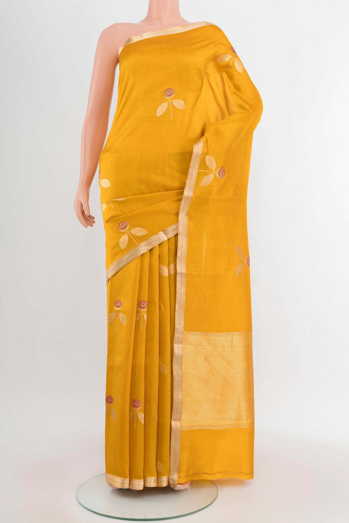Mustard Banarasi Katan Silk Saree with Zari Butta on the body and Silk Border.  displayed on a mannequin