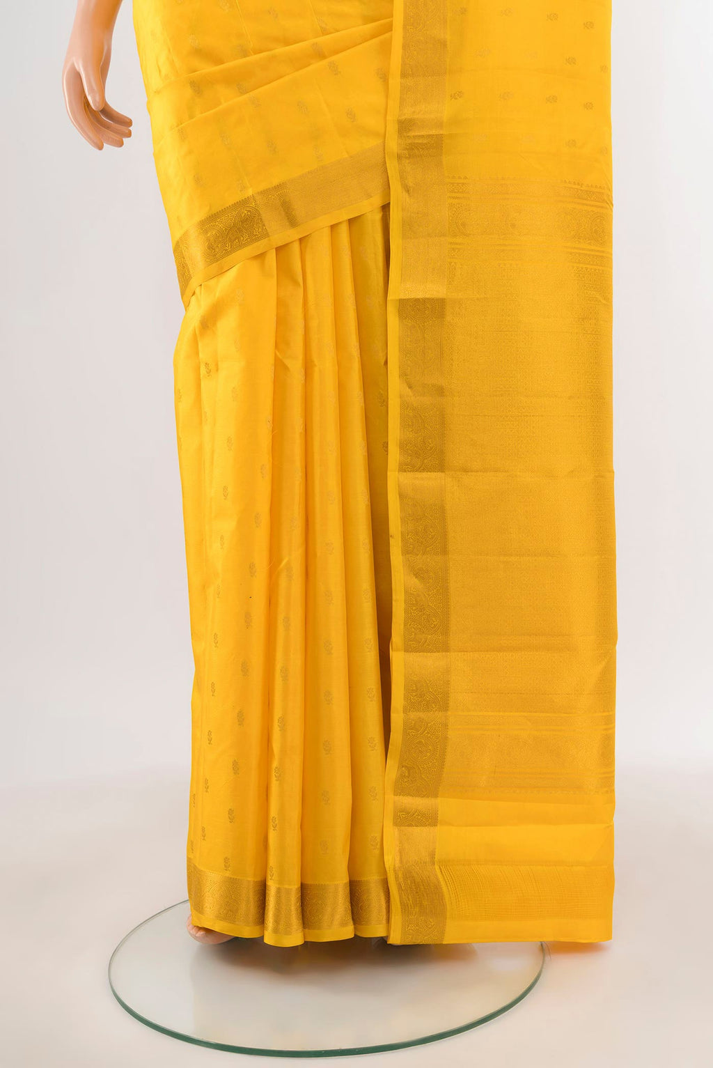 Pleats and pallu of Yellow Kanchipuram Silk Saree with Zari Butta on the body and Zari Border. 