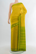 Light Green Kanjivaram Silk Saree with Plain Body and Zari Border.  displayed on a mannequin