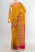 Mustard Kanchipuram Silk Saree with Stripes on the body and Zari Border.  displayed on a mannequin